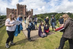 Visitors on a guided tour of the castle and excavations during the Festival of Archaeology 2023 at Powis Castle and Garden, Wales