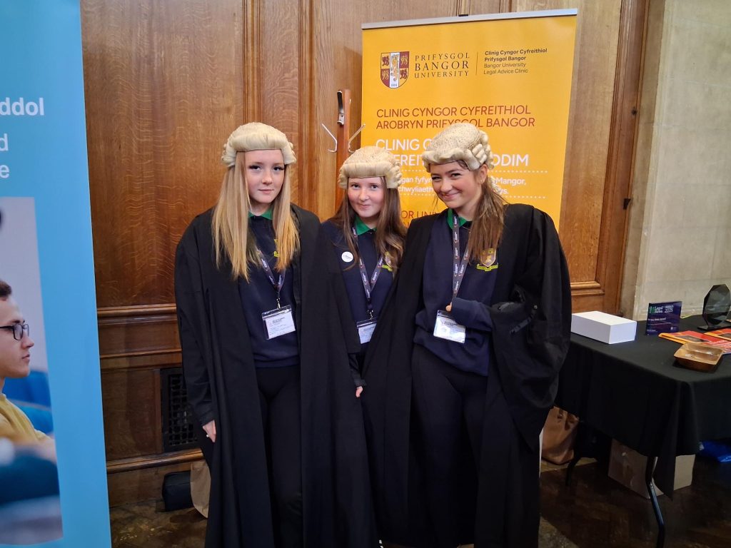 Three-pupils-wearing-barristers-wigs-and-gowns-at-a-careers-event